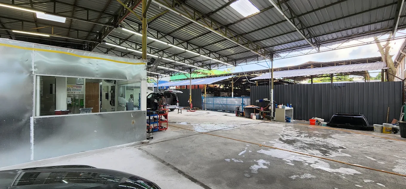 A wide view of the vehicle bays and work area at Speedy Spray